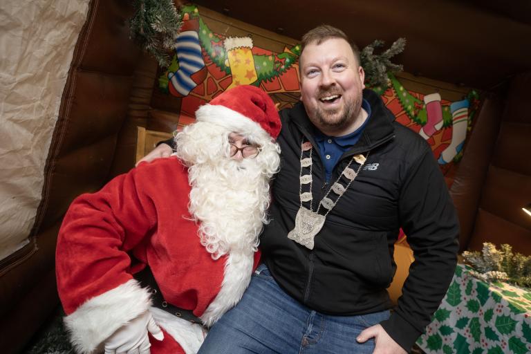 Santa with Smiling Man sitting on Lap